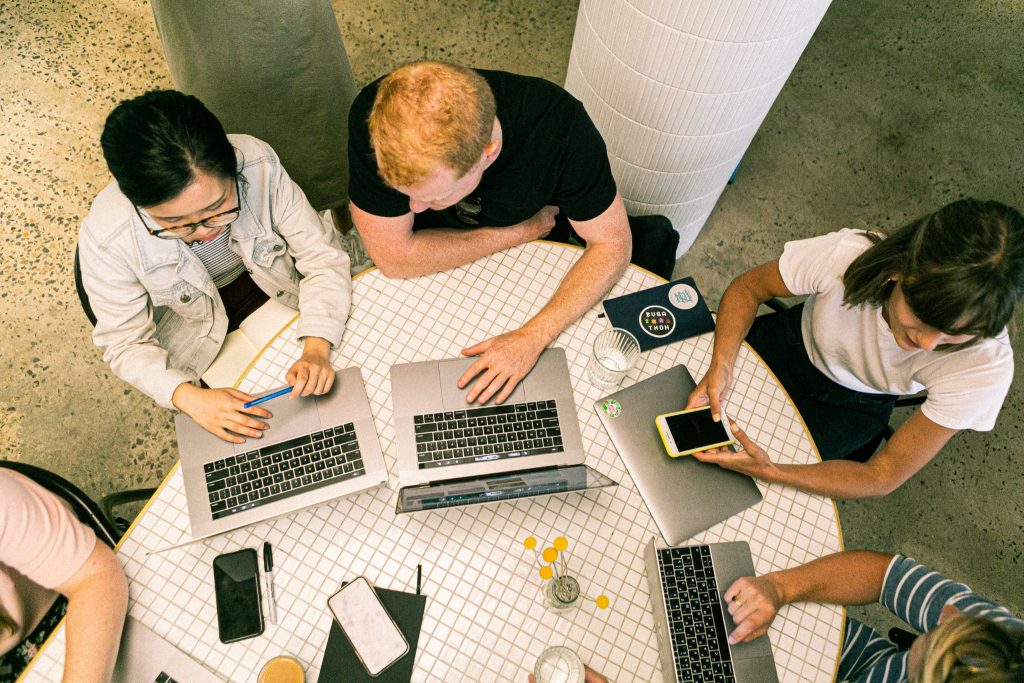 Image of laptop being used by different people
