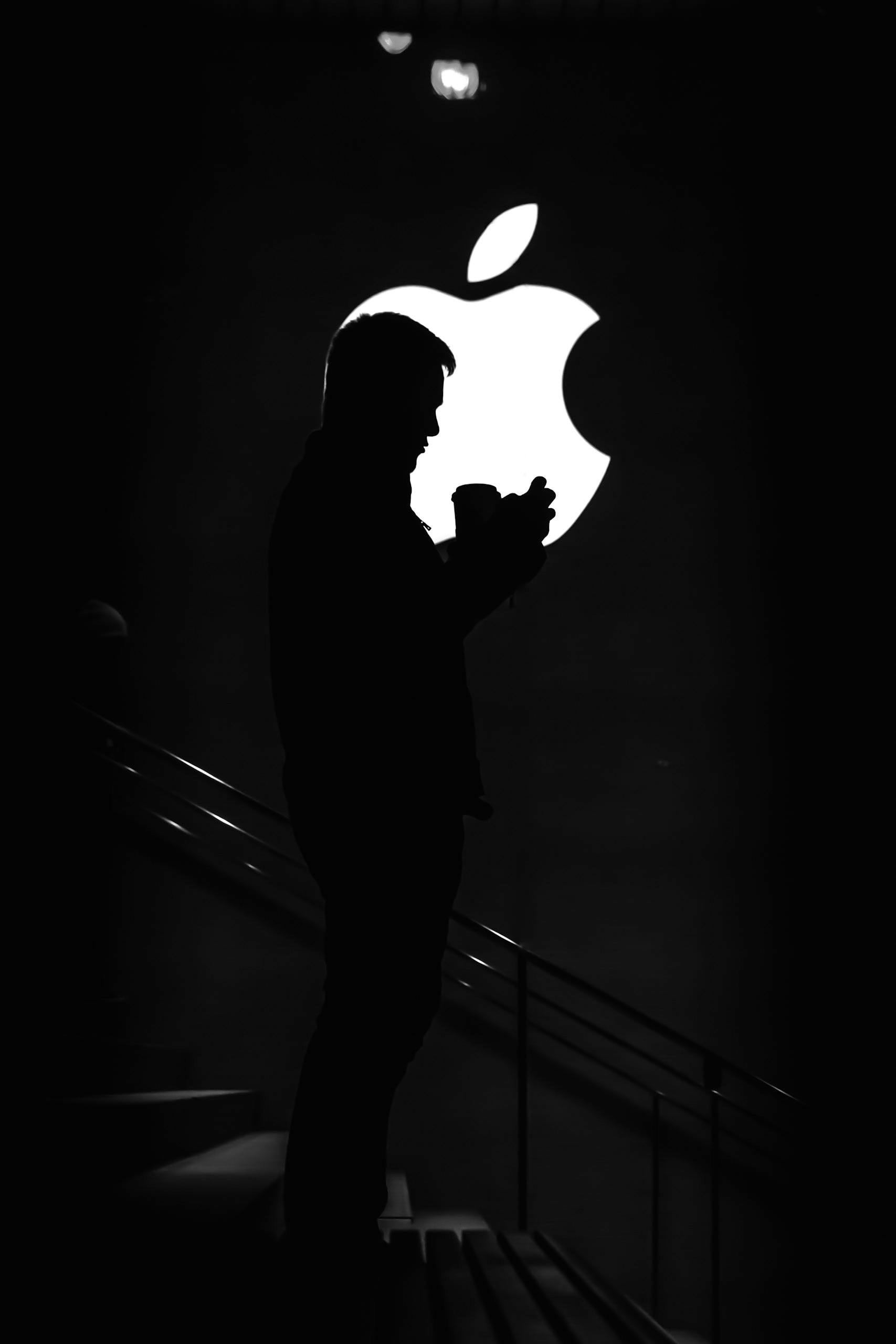Image of a person in front of apple logo