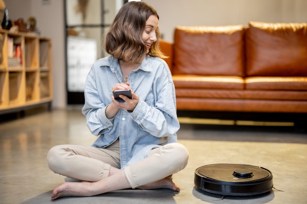 A girl using a robot vacuum