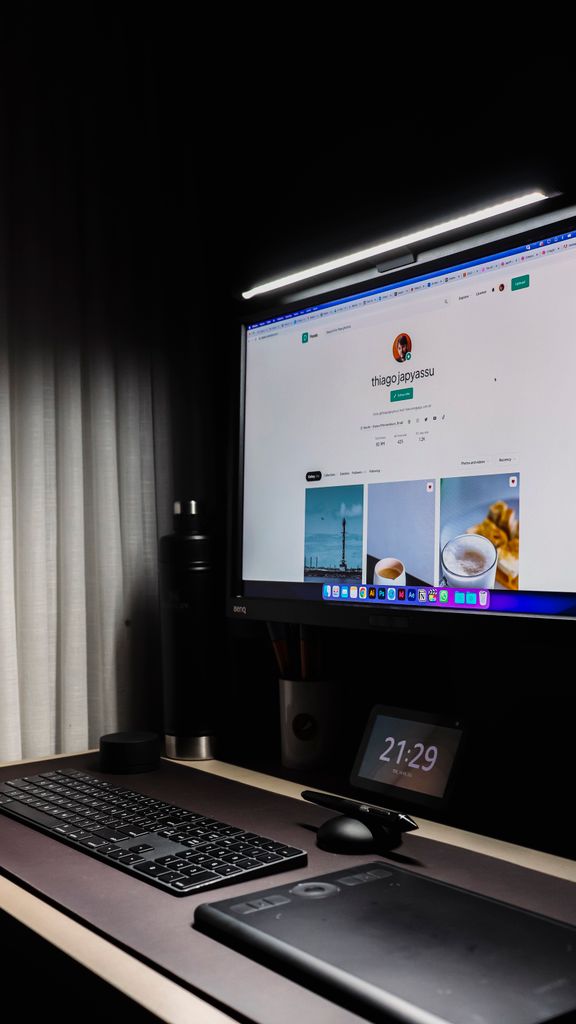 A neat and modern workspace showcasing a monitor with a monitor light bar