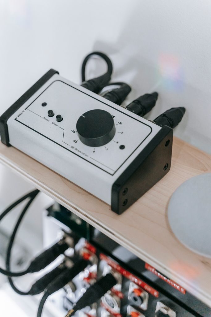 Close-up of a professional audio interface with connected cables and mixer. Perfect for studio settings.