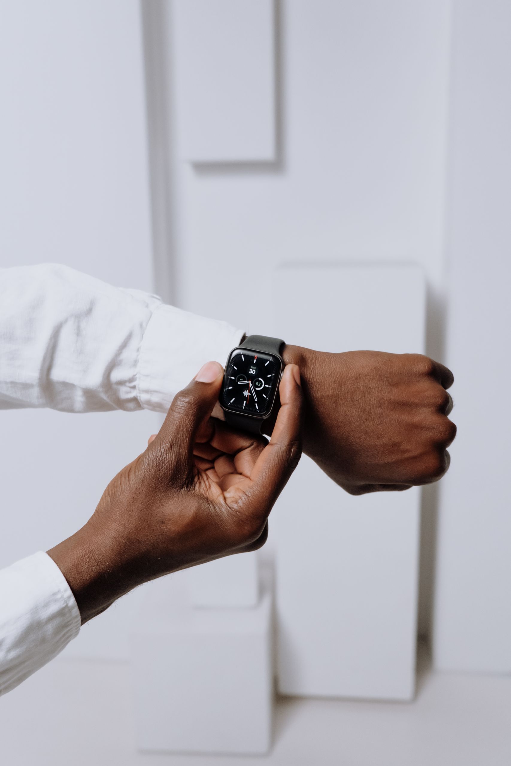 Close-up of a smartwatch on a person's wrist, highlighting modern technology with a minimalist aesthetic.