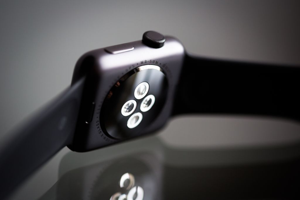 Detailed image of the back sensor of a modern smartwatch showing reflective surface and technology focus.