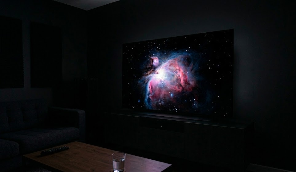 an oled tv displaying it's true black capabilities in a dark room